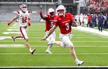 UNLV Rebels quarterback Matthew Sluka (3) scores a touchdown on a keeper during the first half of an NCAA football game against the Utah Tech Trailblazers at Allegiant Stadium Saturday, Sept. 7, 2024. Also pictured are Utah Tech Trailblazers defensive back Brevin Hamblin (12) and UNLV Rebels running back Greg Burrell (5).