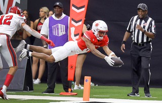 UNLV Rebels wide receiver Timothy Conerly (8) dives into the end zone past Utah Tech Trailblazers defensive back Brevin Hamblin (12) during the second half of an NCAA college football game at Allegiant Stadium Saturday, Sept. 7, 2024.