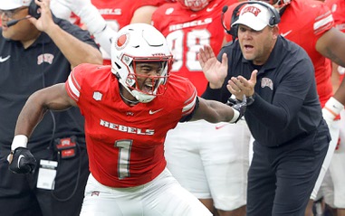 UNLV Rebels defensive back Jalen Catalon (1) celebrates after making a tackle during the first half of an NCAA college football game against the Utah Tech Trailblazers at Allegiant Stadium Saturday, Sept. 7, 2024. UNLV Rebels head coach Barry Odom applauds at right.