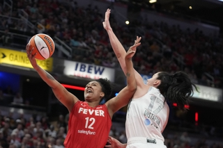 Indiana Fever's Damiris Dantas (12) shoots against Las Vegas Aces' Megan Gustafson (17) during the first half Wednesday, Sept. 11, 2024, in Indianapolis. 


