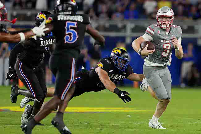 UNLV quarterback Matthew Sluka (3) gets past Kansas defensive end Dylan Wudke (95) as he runs in the second half during an NCAA college football game Friday, Sept. 13, 2024, at Children's Mercy Park in Kansas City, Kan. (AP Photo/Ed Zurga)