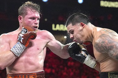 Canelo Alvarez hits Edgar Berlanga in a super middleweight title bout Saturday, Sept. 14, 2024, in Las Vegas.