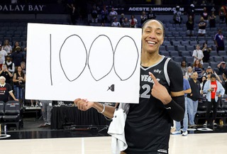 Las Vegas Aces center A'ja Wilson (22) poses after an WNBA basketball game against the Connecticut Sun Sunday, Sept. 15, 2024, in Las Vegas. Wilson scored 29 points in the game to become the first WNBA player in WNBA history to reach 1,000 points in a regular season.