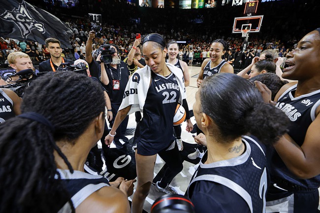 Las Vegas Aces center A'ja Wilson, center, celebrates with teammates after an WNBA basketball game against the Connecticut Sun, Sunday, Sept. 15, 2024, in Las Vegas. Wilson scored 29 points in the game to become the first player in WNBA history to reach 1,000 points in a regular season.