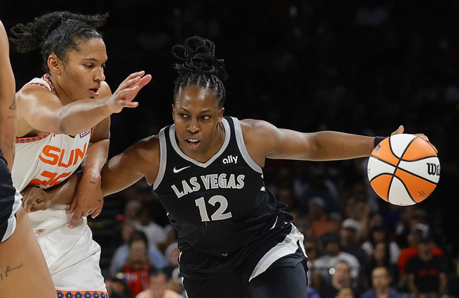 Las Vegas Aces guard Chelsea Gray (12) drives against Connecticut Sun forward Alyssa Thomas (25) during the second half of an WNBA basketball game Sunday, Sept. 15, 2024, in Las Vegas.