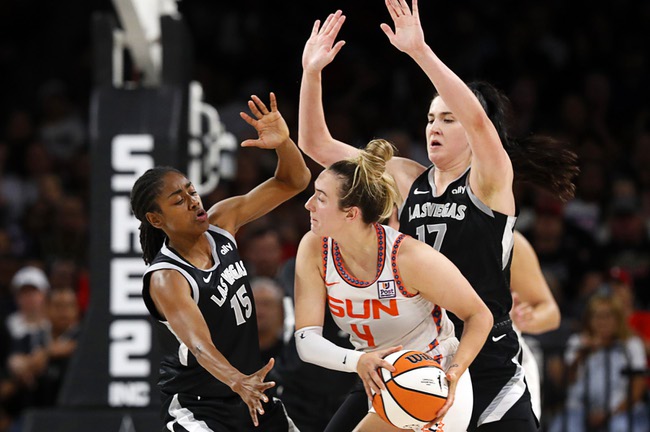 Las Vegas Aces guard Tiffany Hayes (15) and center Megan Gustafson (17) defend against Connecticut Sun guard Marina Mabrey (4) during the second half of an WNBA basketball game Sunday, Sept. 15, 2024, in Las Vegas.