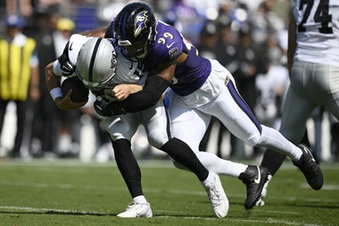 Baltimore Ravens linebacker Odafe Oweh (99) sacks Las Vegas Raiders quarterback Gardner Minshew (15) during the first half of an NFL football game, Sunday, Sept. 15, 2024, in Baltimore. 