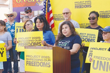 Rosina Barrientos, at lectern, a Las Vegas member of the American Federation of State, County and Municipal Employees, flanked at her right by Susie Martinez, the executive secretary treasurer of the Nevada State AFL-CIO, participate in a rally for Vice President Kamala Harris’ presidential campaign.