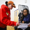 Photo: Tracie Deguzman, 23, left, helps Jaeden Jones, 17,