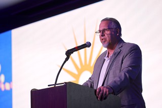 Shawn Jenkins, COO of WestCare, Western Region, speaks during a WestCare Nevada graduation ceremony in the Tony Hsieh Theater at Zappos Tuesday, Sept. 17, 2024.