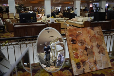 Buyers of all ages filled wagons and luggage carts with arm chairs priced at $25, mirrors at $6, floor lamps at $28.