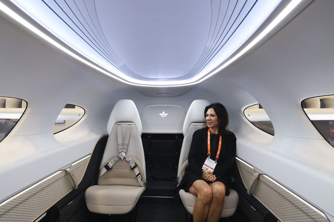 An attendee sits in the cabin of a Lilium electric vertical take-off and landing jet during the National Business Aviation Association Convention & Exhibition at the Las Vegas Convention Center Tuesday, Oct. 22, 2024.