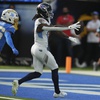 Tennessee Titans wide receiver Calvin Ridley, right, scores a touchdown past Los Angeles Chargers cornerback Ja'Sir Taylor (36) during the first half of an NFL football game Sunday, Nov. 10, 2024, in Inglewood, Calif.