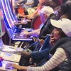 A gambler plays a slot machine while smoking at the Hard Rock casino in Atlantic City, N.J., on Oct. 3, 2024.