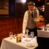 Photo: Waiters clear the tables at a private event held a