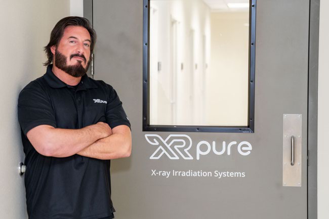 Joseph Bancheri, Sales Manager at XR Pure, an advance irradiation system solution for cannabis producers, capable of eliminating mold, bacteria, mildew and other harmful pathogens, poses with one of the x-ray tubes in Las Vegas, Nevada on Thursday, January 16, 2025.