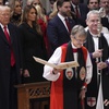 Photo: President Donald Trump, left, watches as Rev. Mari