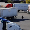 Photo: A man walks across the parking lot at the TA Trave
