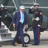 Photo: President Donald Trump is greeted by Air Force Col