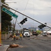 Photo: Workers survey downed traffic lights and power lin