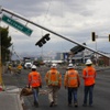 Photo: Workers survey downed traffic lights and power lin