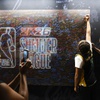 Photo: Fans sign a wall during NBA Summer League at Thoma