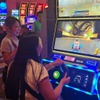 A player gives the new Running Rich Grand Prix slot machine a spin. “It truly is a hybrid slot machine,” Competition Interactive CEO Paul Steelman said of the game, which features cars and characters, free spins and bonuses that allow players to play a video game race.