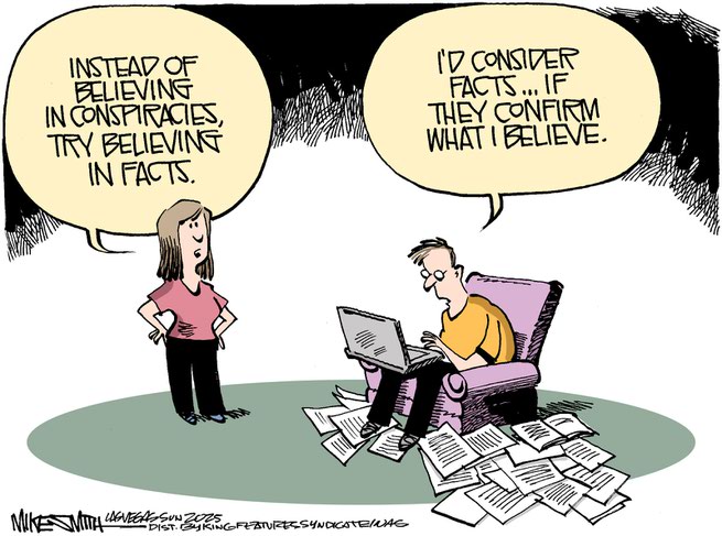 Man sitting in chair hunched over laptop and surrounded by papers scattered on the floor.  Woman says, 