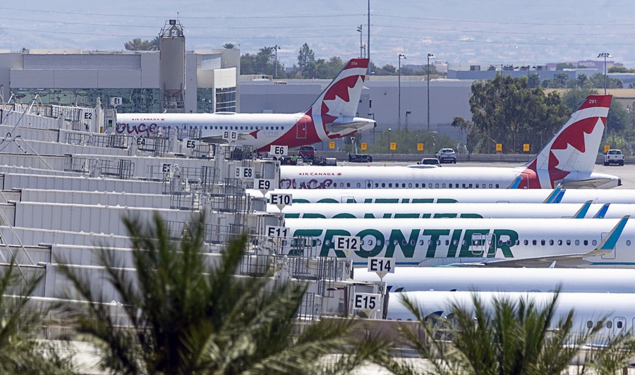 Air Canada and Frontier Airlines passenger jets are shown at terminal 3 gates at Harry Reid International Airport Wednesday, Aug. 13, 2025.