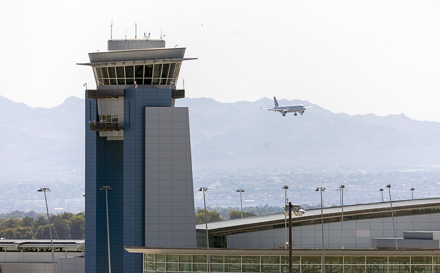 A view of the airport traffic control Tower at Harry Reid International Airport as an American Airlines passenger jet comes in for a landing Wednesday, Aug. 13, 2025.