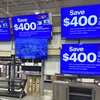 Photo: Flat screen TVs are displayed at a retail store in