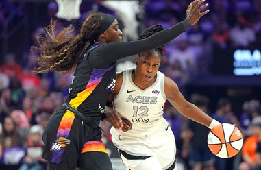 Las Vegas Aces guard Chelsea Gray (12) drives on Phoenix Mercury guard Kahleah Copper during the first half of Game 4 of the WNBA basketball finals Friday, Oct. 10, 2025, in&nbsp;Phoenix.