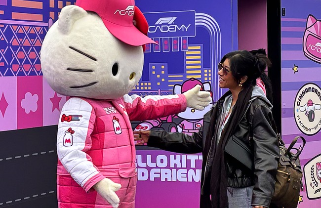 Hello Kitty greets a race fan at the Hello Kitty F1 Pit Stop Cafe during the 2025 F1 Las Vegas Grand Prix Friday, Nov. 21, 2025.