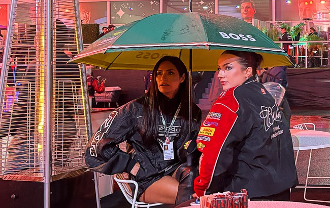 Race fans shelter under umbrellas in the Grand Prix Plaza during the 2025 F1 Las Vegas Grand Prix Friday, Nov. 21, 2025.