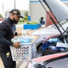 Renalto Hardin, with Vegas Youth Ambassadors, in association with NAIOP of Southern Nevada’s community service committee, distributes baskets of food and groceries to families at Walter V. Long Elementary School Friday Nov. 21, 2025.
