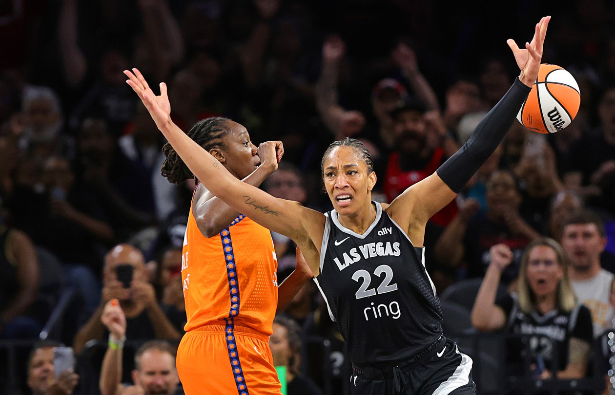 Las Vegas Aces center A’ja Wilson (22) reacts after scoring a basket against Connecticut Sun center Tina Charles, left, to achieve her 5,000th career point in the WNBA during the first half of a WNBA basketball game in Michelob Ultra Arena at Mandalay Bay Wednesday, June 25, 2025. STEVE&nbsp;MARCUS