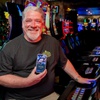 A casino customer displays the Koin app while sitting at a slot machine. App users can scan a QR code to transfer their choice of a monetary amount to gaming devices.