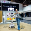 Photo: An AI-enabled home robot poses with show attendees