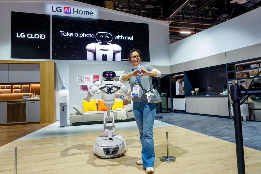 An AI-enabled home robot poses with show attendees at the LG booth Tuesday, Jan. 6, 2026, at CES 2026 in Las Vegas. 