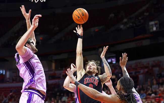 UNLV guard Dra Gibbs-Lawhorn (0) puts up a shot in triple coverage during the second half of an NCAA college basketball game against Grand Canyon at the Thomas & Mack Center Saturday, Feb. 7, 2026.