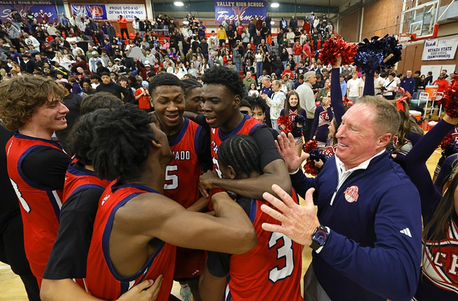 Coronado basketball head coach Jeff Kaufman, right, celebrates with players after Coronado beat Liberty in the boy’s 5A state championship basketball game at Valley High School Friday, Feb. 20, 2026. Coronado defeated Liberty 60-55.