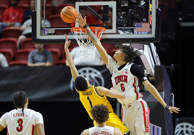 UNLV forward Tyrin Jones (6) blocks a shot by Wyoming guard Damarion Dennis (1) in the first half of an NCAA college basketball game during the 2026 Credit Union 1 Mountain West Basketball Championships tournament at the Thomas & Mack Center Wednesday, March 11, 2026.