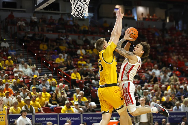 UNLV guard Dra Gibbs-Lawhorn (0) drives to the basket against Wyoming forward Simm Saadi (35) in the first half of an NCAA college basketball game during the 2026 Credit Union 1 Mountain West Basketball Championships tournament at the Thomas & Mack Center Wednesday, March 11, 2026.