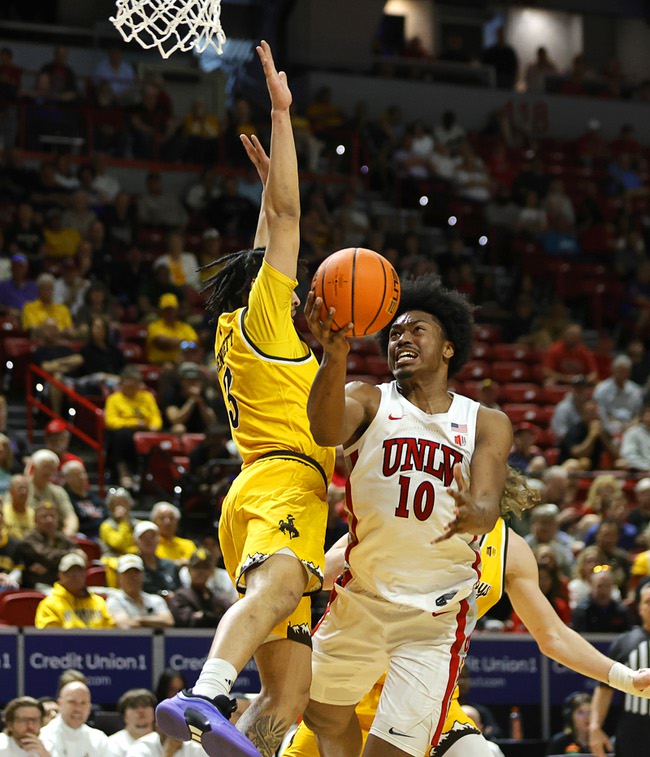 UNLV forward Jacob Bannarbie (10) shoots a layup against Wyoming guard Khaden Bennett (3) in the first half of an NCAA college basketball game during the 2026 Credit Union 1 Mountain West Basketball Championships tournament at the Thomas & Mack Center Wednesday, March 11, 2026.