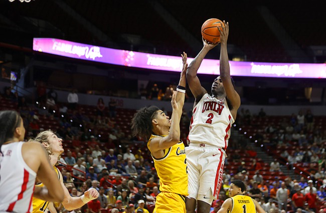 UNLV forward Kimani Hamilton (2) shoots over Wyoming guard Nasir Meyer (2) to tie the game with 19.3 seconds left in the second half of an NCAA college basketball game during the 2026 Credit Union 1 Mountain West Basketball Championships tournament at the Thomas & Mack Center Wednesday, March 11, 2026. Hamilton was fouled and made his free throw to put UNLV ahead.