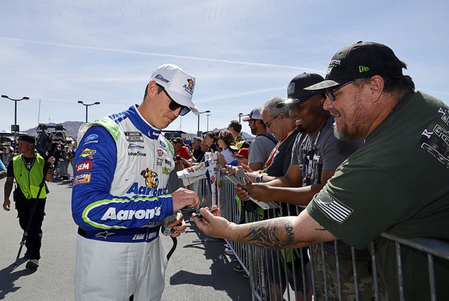 signs an autograph for a fan before a NASCAR Cup Series auto race at Las Vegas Motor Speedway Sunday, March 15, 2026, in Las Vegas.