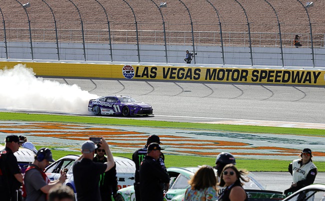 Denny Hamlin (11) performs a burnout after winning a NASCAR Cup Series auto race at Las Vegas Motor Speedway Sunday, March 15, 2026, in Las Vegas.