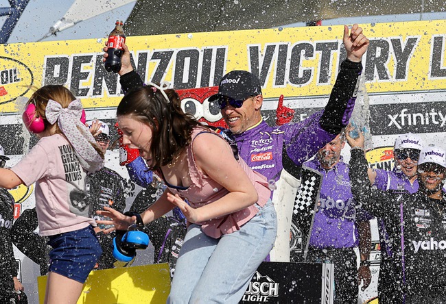 Denny Hamlin (11) celebrates in Victory Lane with his daughters Molly, left, and Taylor after winning a NASCAR Cup Series auto race at Las Vegas Motor Speedway Sunday, March 15, 2026, in Las Vegas.