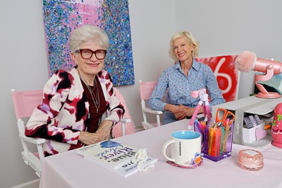 Nancy Nelson, left, who was diagnosed with early-onset Alzheimer’s in 2013, poses with Kat Hartley in a room where they record their “dangle & dot” podcasts Tuesday, March 31, 2026.