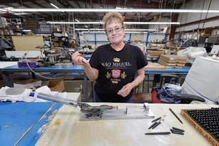 Jackie Silva poses with a pen in a production department at the Fisher Space Pen factory in Boulder City Thursday, April 2, 2026.